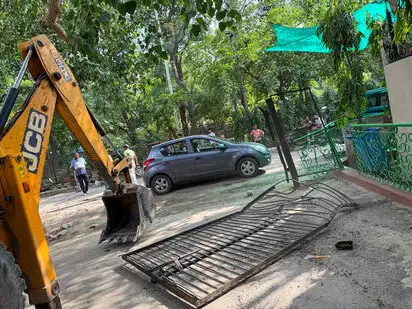 DTCP enforcement team in action removing unauthorized gates in South City 1, Gurugram.
