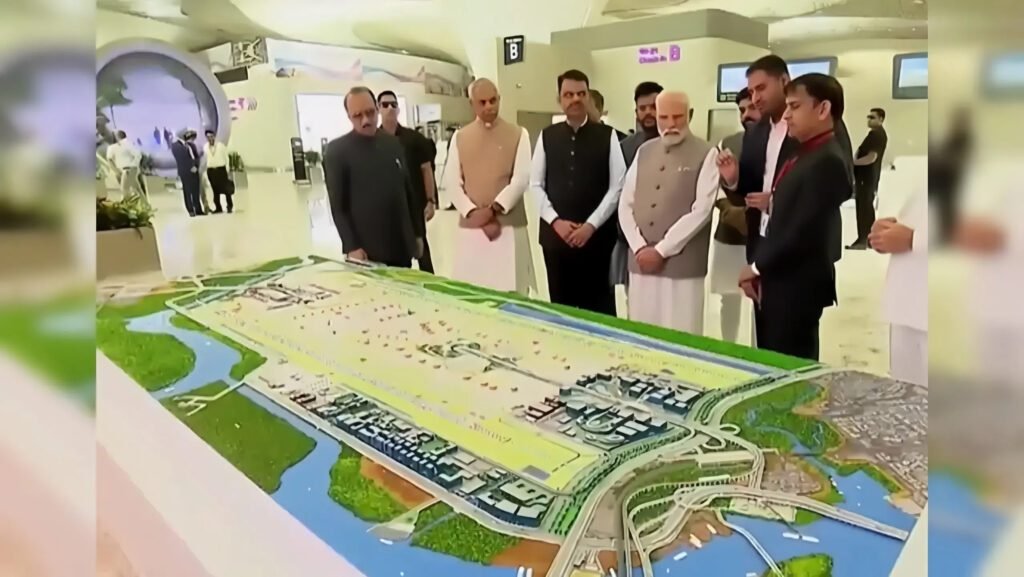 Prime Minister Narendra Modi reviews the scale model of the newly inaugurated Navi Mumbai International Airport along with senior government officials and project representatives.