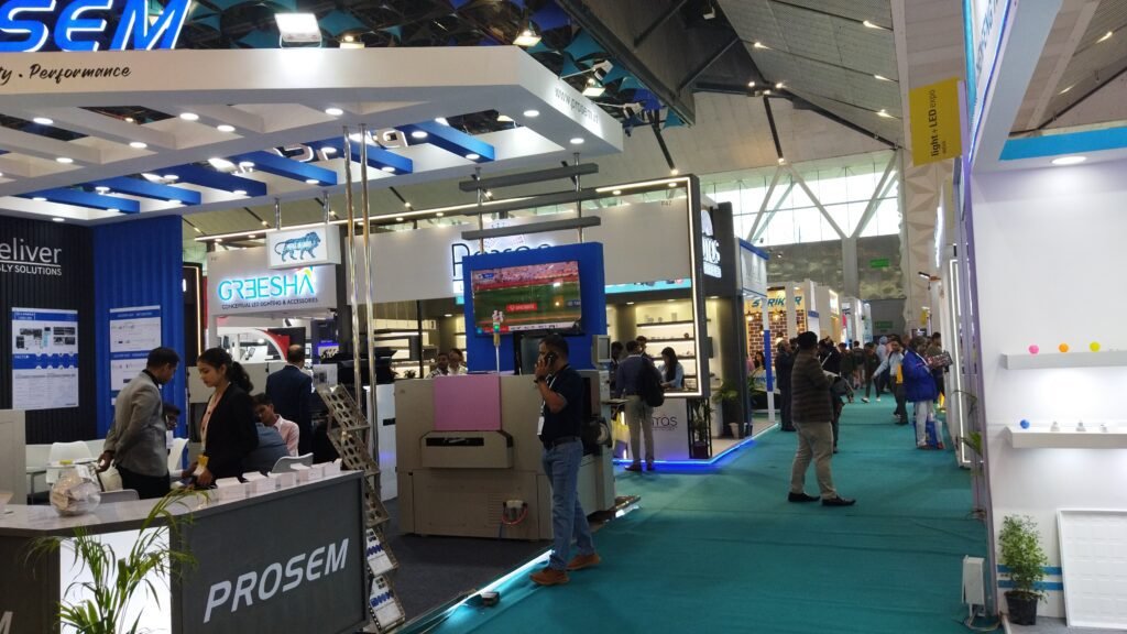Interior view of the Light + LED Expo at Yashobhoomi Exhibition Hall, showcasing modern booth design and visitor interaction.