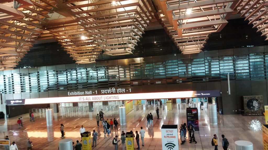 Wide-angle view of Yashobhoomi Exhibition Hall 1 entrance with digital signage and visitors during an ongoing expo.