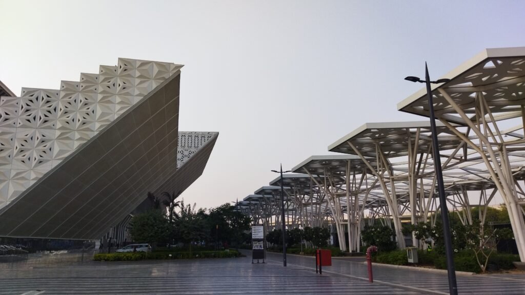 Exterior architecture of Yashobhoomi convention centre featuring angular façade patterns and landscaped pedestrian walkways.
