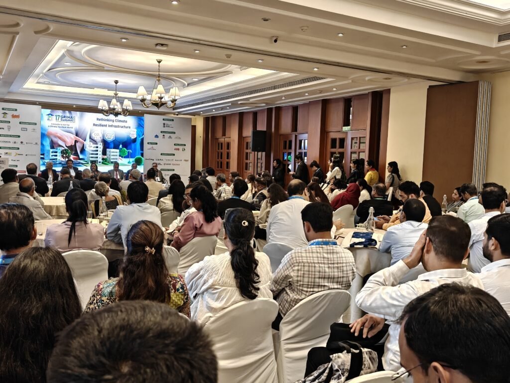 A packed audience attending a technical session on “Rethinking Climate Resilient Infrastructure” at the 17th GRIHA Summit 2025, with speakers discussing sustainable development strategies.