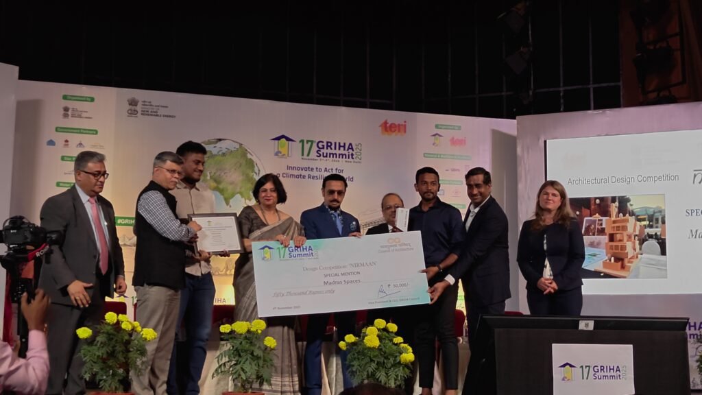 Winners from ARCS Design Studio, Mumbai, receiving the first prize for the Nirmaan Architectural Design Competition at the 17th GRIHA Summit 2025, holding a ₹75,000 cheque along with dignitaries on stage.