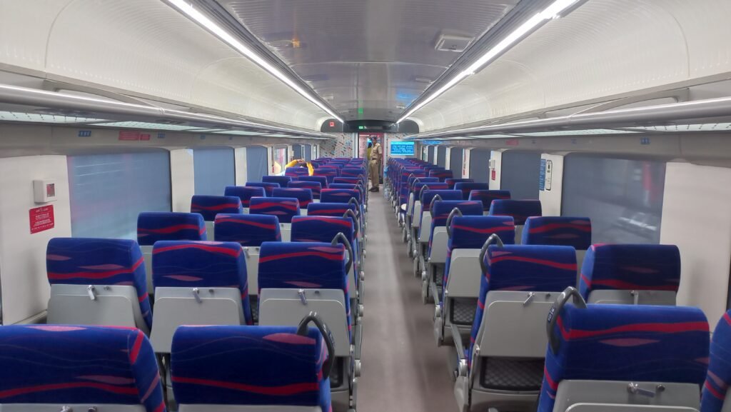 Inside view of Vande Bharat Express with modern seating and LED lighting