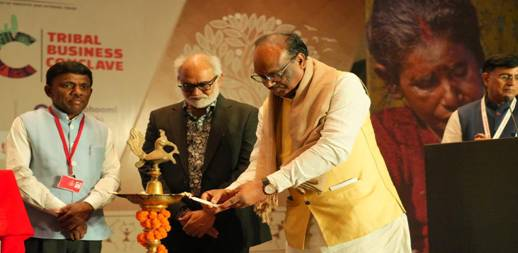 Minister Shri Durgadas Uikey lighting the ceremonial lamp during the inauguration of the Tribal Business Conclave 2025.