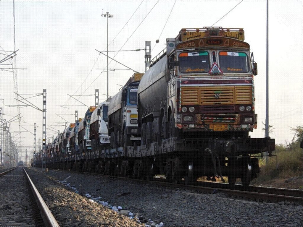 Trucks loaded on freight trains operating on India’s Dedicated Freight Corridor under Indian Railways’ Trucks-on-Trains service