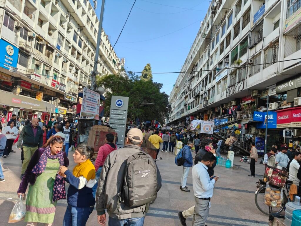 Public space activity in front of mid-rise commercial blocks at Nehru Place district centre, Delhi