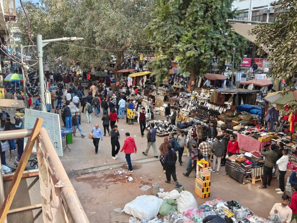 Dense street life and electronics market activity in the pedestrian zone of Nehru Place, Delhi