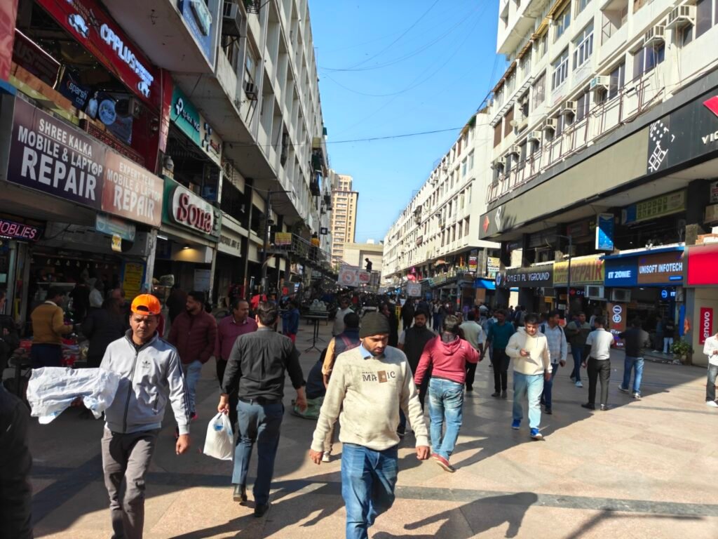 Main pedestrian movement corridor lined with electronics and service shops at Nehru Place, Delhi