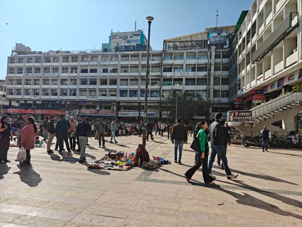 Open public square at Nehru Place with informal vendors and pedestrian movement in Delhi