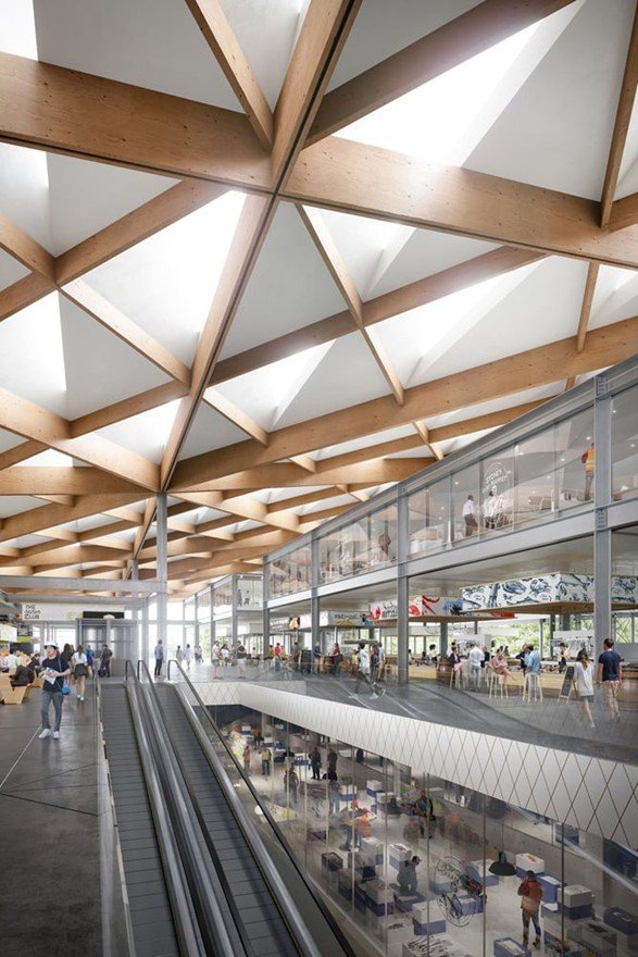 Interior view of the Sydney Fish Market showing a glazed public walkway overlooking wholesale seafood operations beneath the timber roof structure.