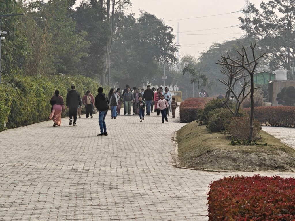 Visitors walking along pathway inside Baansera Yamuna floodplain park Delhi