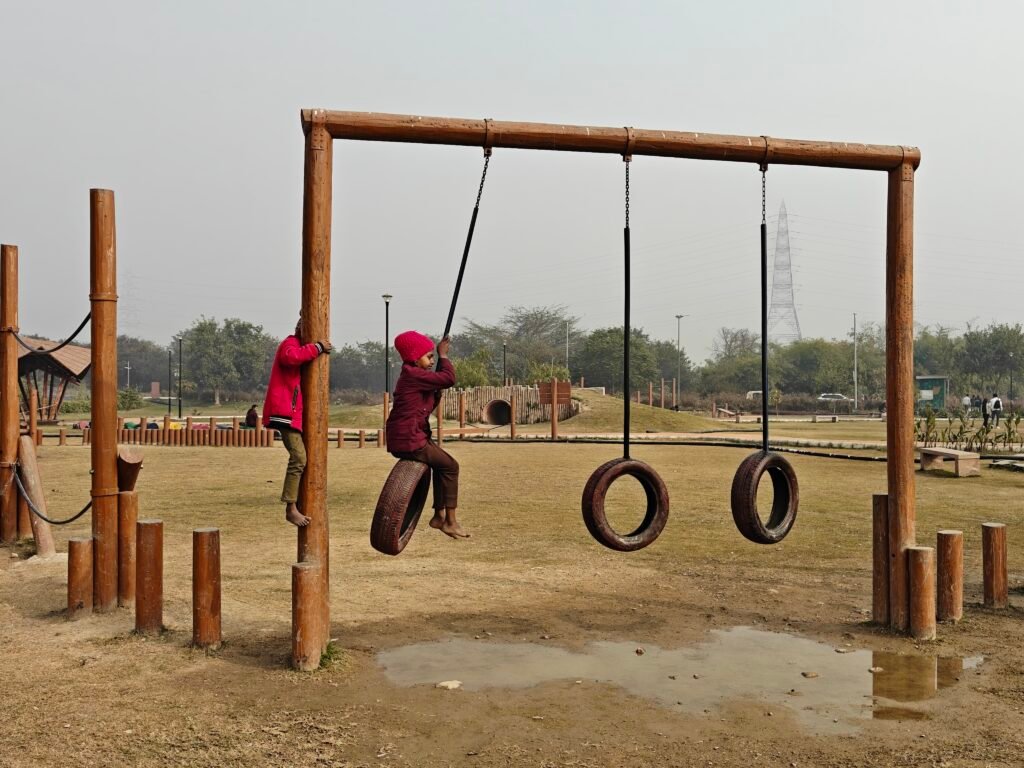 Children playing on tyre swings at Baansera eco-friendly playground Delhi