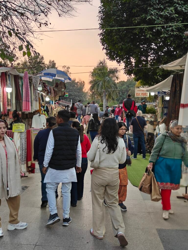 Crowded bazaar street at Dilli Haat INA with shoppers and handicraft stalls