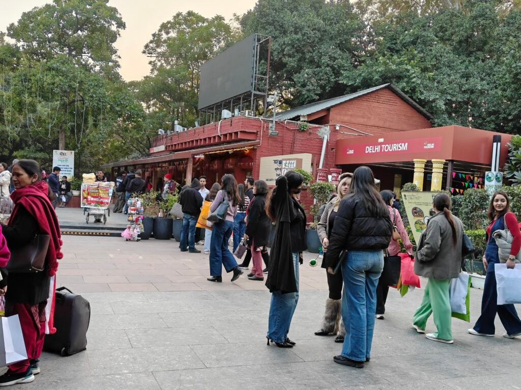 Visitors at Dilli Haat INA entry plaza near Delhi Tourism counter in New Delhi