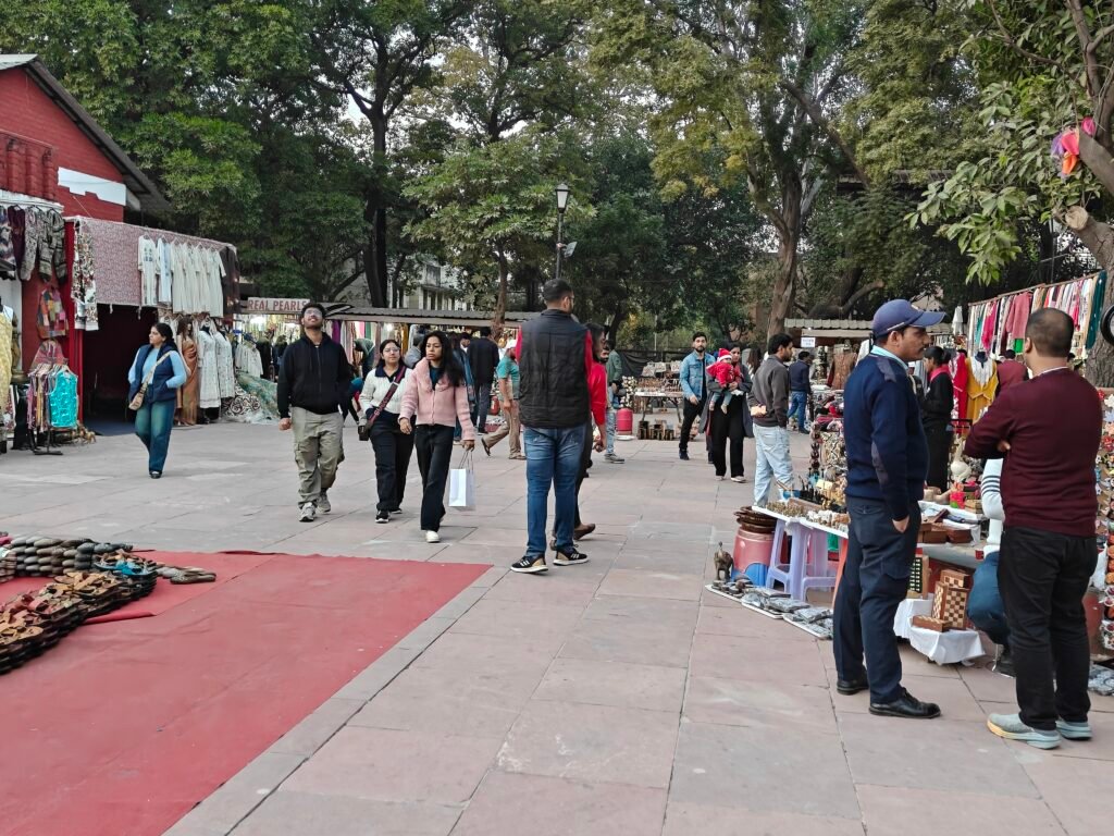 Pedestrian bazaar street at Dilli Haat INA with shops, visitors and open walkway