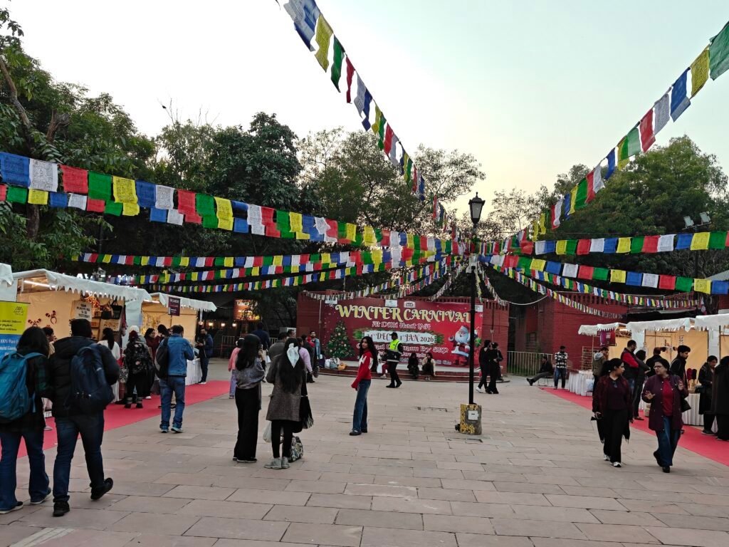 Cultural plaza at Dilli Haat INA decorated with flags during winter carnival event