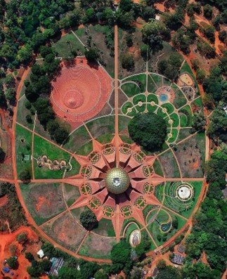 Aerial view of Matrimandir showing radial site layout gardens and pathways in Auroville