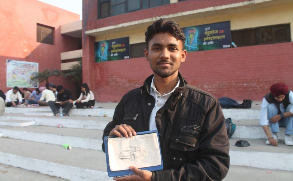 Student displaying handmade canvas artwork at NEXUS 2026 GNDEC