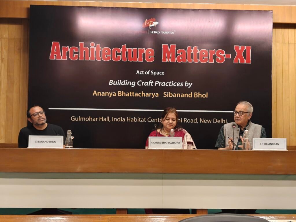Speakers seated during Architecture Matters XI with event backdrop at India Habitat Centre