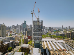 Atlassian Central timber skyscraper under construction above Sydney Central Station with cranes and hybrid steel structure