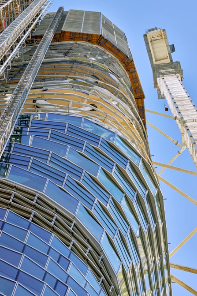 Low-angle view of Atlassian Central highlighting curved facade and structural framework