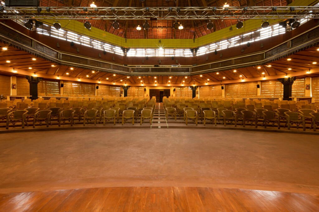 Interior view of Bharata Kalashettram auditorium with traditional timber roof structure