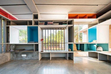 Compact modular interior with integrated furniture and colorful storage designed by architect Anupama Kundoo