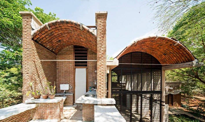 Exterior view of brick vaulted roof structure designed by Anupama Kundoo in Auroville