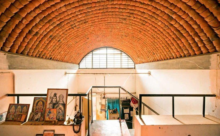 Interior space with terracotta vaulted roof designed by architect Anupama Kundoo using sustainable brick construction