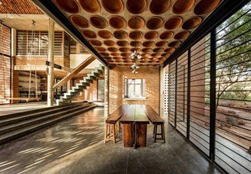 Interior view of Wall House designed by architect Anupama Kundoo featuring terracotta ceiling elements and sustainable material use