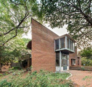Exterior facade of Wall House in Auroville designed by architect Anupama Kundoo using exposed brick and climate-responsive design