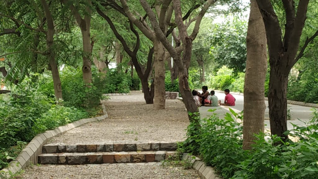 Children and residents enjoying the restored public landscape at the Bundh Rejuvenation Trail in Gurugram.