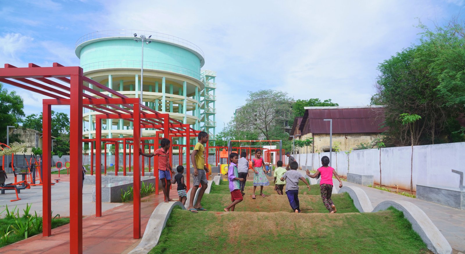 Children playing on landscaped mounds at Community Plug public park designed by Studio Aranya.
