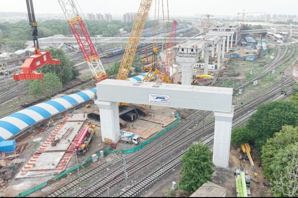 Heavy portal beam being launched for the Mumbai–Ahmedabad Bullet Train project over operational railway tracks in Ahmedabad.