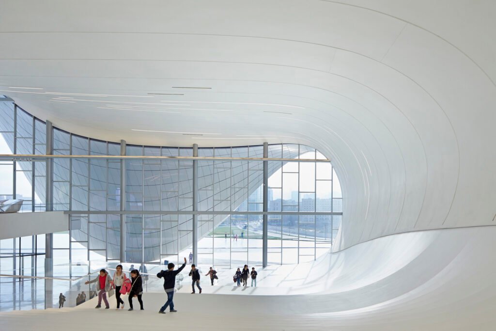 Curved interior lobby of the Heydar Aliyev Center showcasing fluid architecture and natural daylight.
