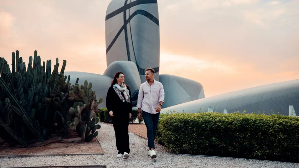 Visitors approach the King Abdulaziz Center for World Culture (Ithra), showcasing Snøhetta's sculptural architecture in Dhahran, Saudi Arabia.