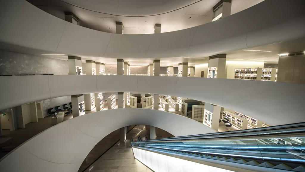 The multi-storey library at Ithra features fluid architectural forms and naturally illuminated reading spaces.