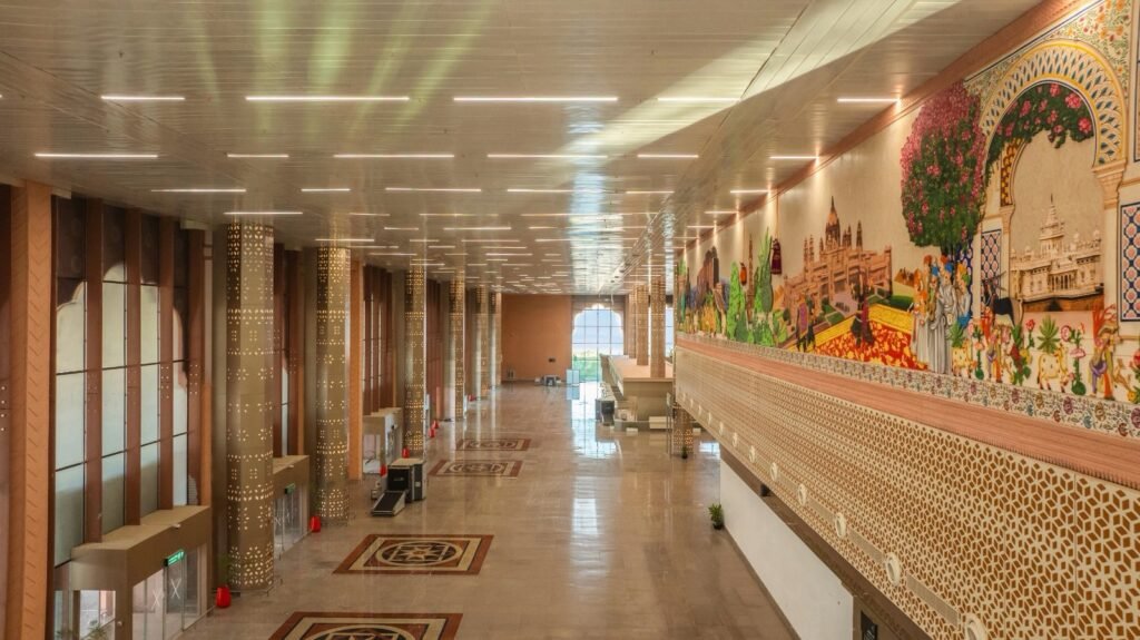 Arrival hall of the new Jodhpur Airport terminal featuring a large mural showcasing Rajasthan's cultural heritage.