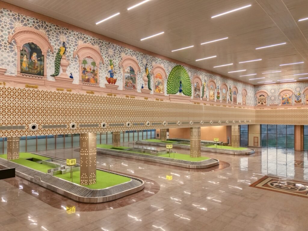 Baggage claim area inside the new Jodhpur Airport terminal with heritage-inspired artwork and modern passenger facilities.