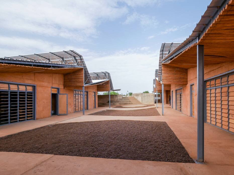 Clay-walled classroom modules and covered walkways at Burkina Institute of Technology