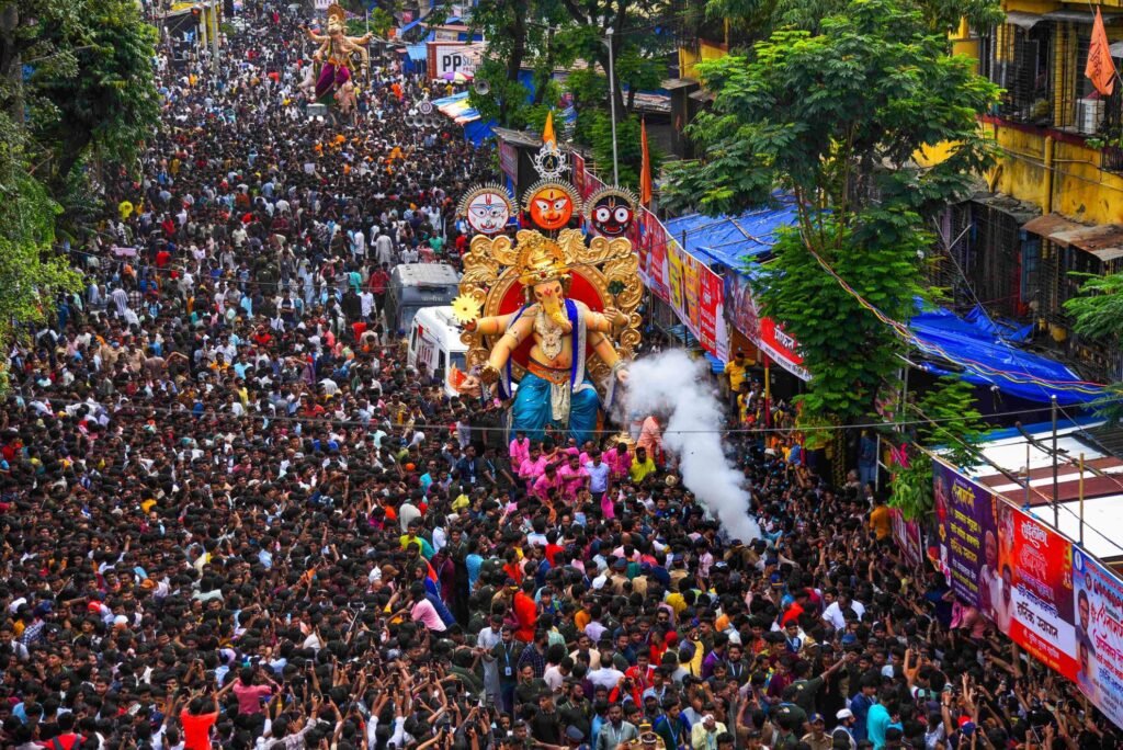 Massive Ganesh Utsav procession filling a Mumbai street