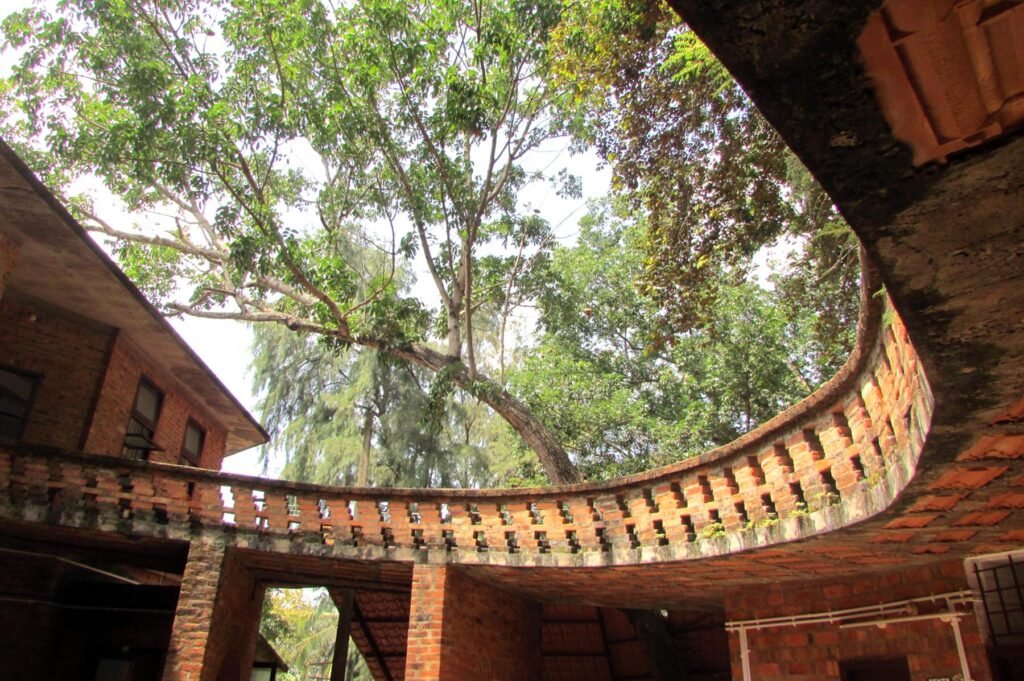 Brick staircase and curved landscape elements at Laurie Baker’s CDS auditorium