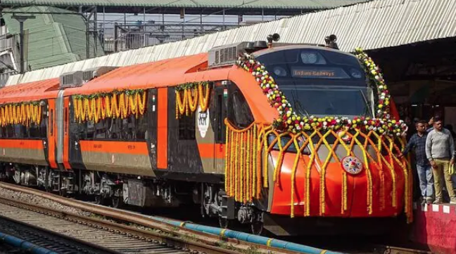 Sleeper Vande Bharat Express train decorated for inauguration at a railway station.