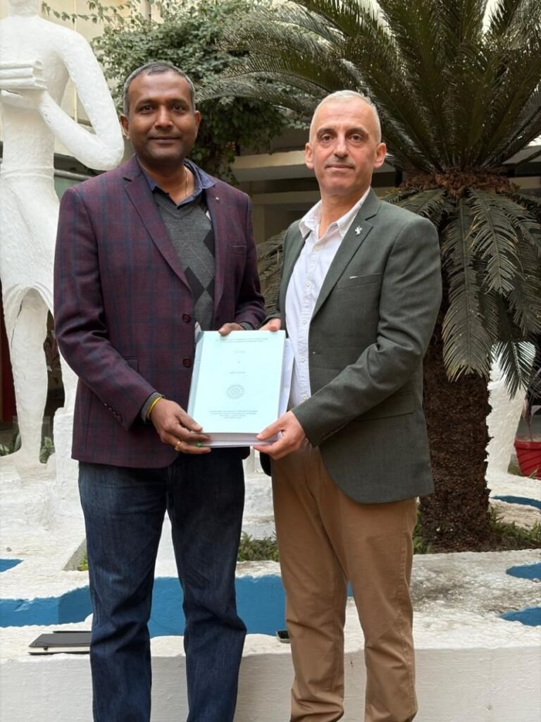 Dr. Ghieth Alwarah with Professor Ram Satish Pasupuleti holding his doctoral thesis.