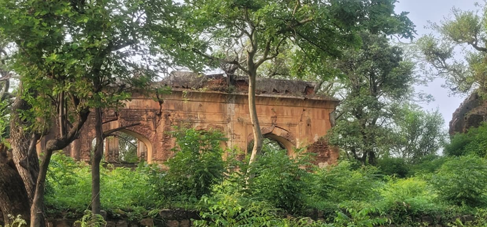 Weathered historic structure with arched openings at Jasrota Fort, Kathua.
